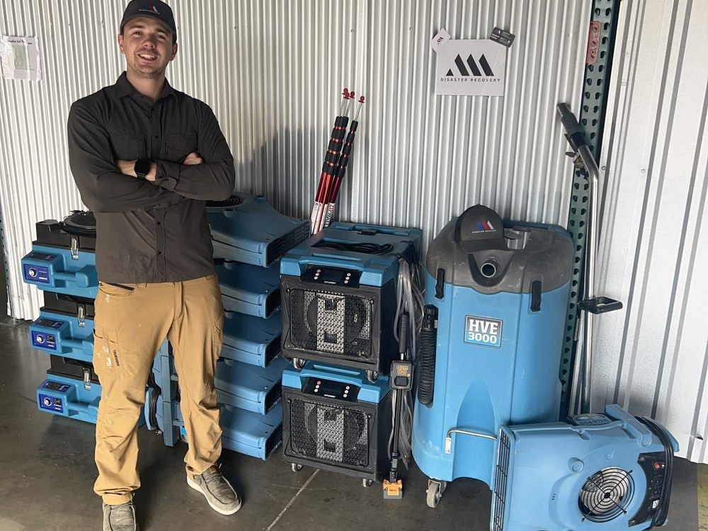 AAA Disaster Recovery owner with the company's commercial dehumidifiers, air movers and HVE 3000 extractor at the Austin shop